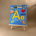 Wipe-clean book for learning letters on a stand with a brown background