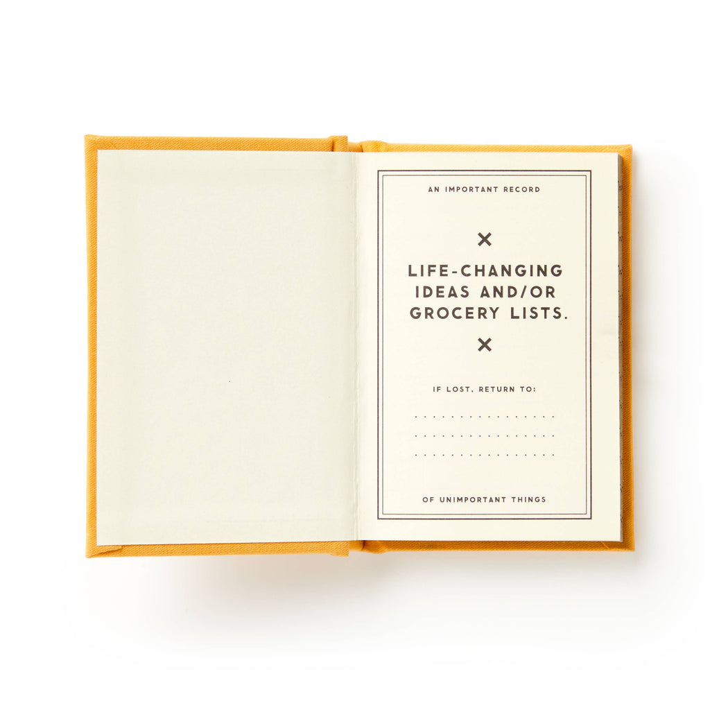 Mustard yellow notebook open to title page for life-changing ideas and grocery lists, perfect for intentional planning.