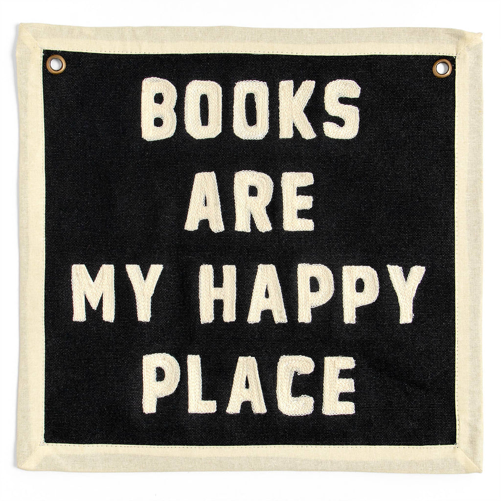 Black wall banner with cream embroidered text: 'BOOKS ARE MY HAPPY PLACE' — cozy reading decor for book lovers