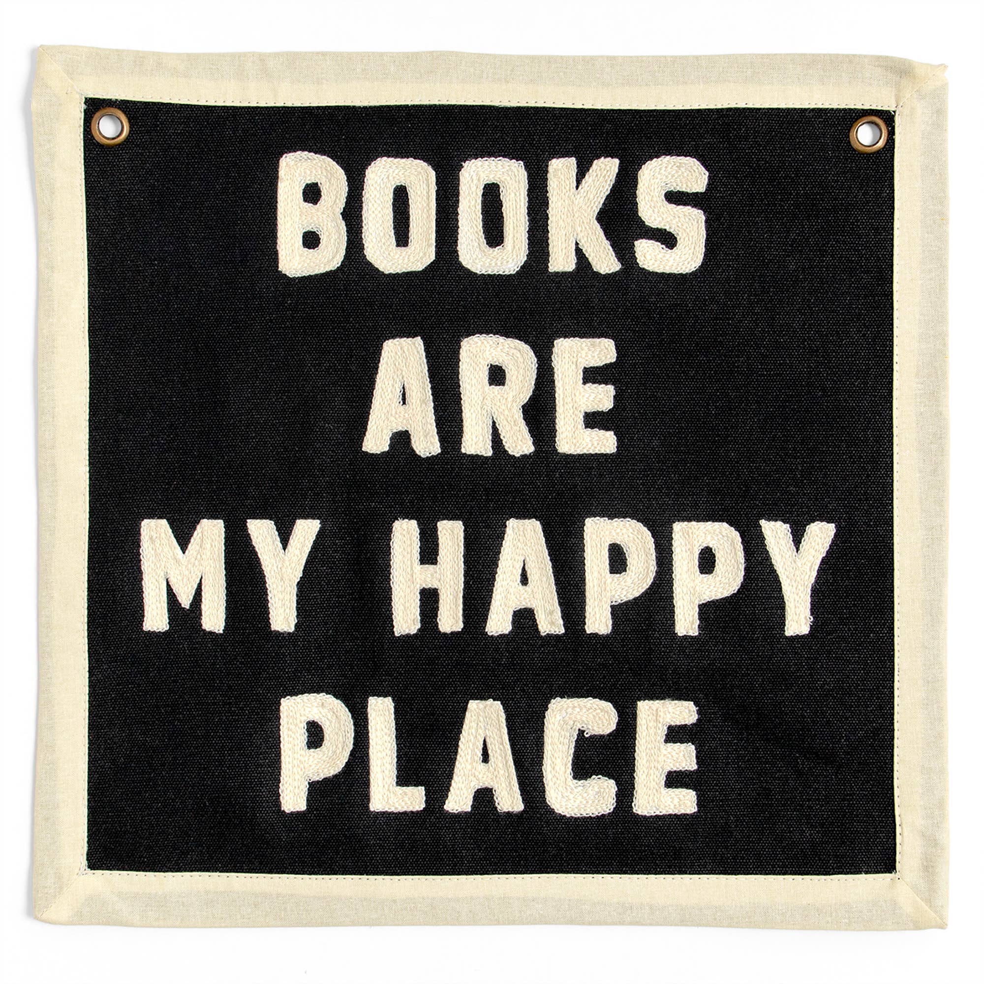 Black wall banner with cream embroidered text: 'BOOKS ARE MY HAPPY PLACE' — cozy reading decor for book lovers