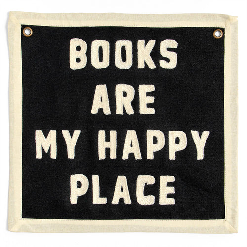 Black wall banner with cream embroidered text: 'BOOKS ARE MY HAPPY PLACE' — cozy reading decor for book lovers