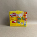 Play-Doh flower set packaging on a beige background