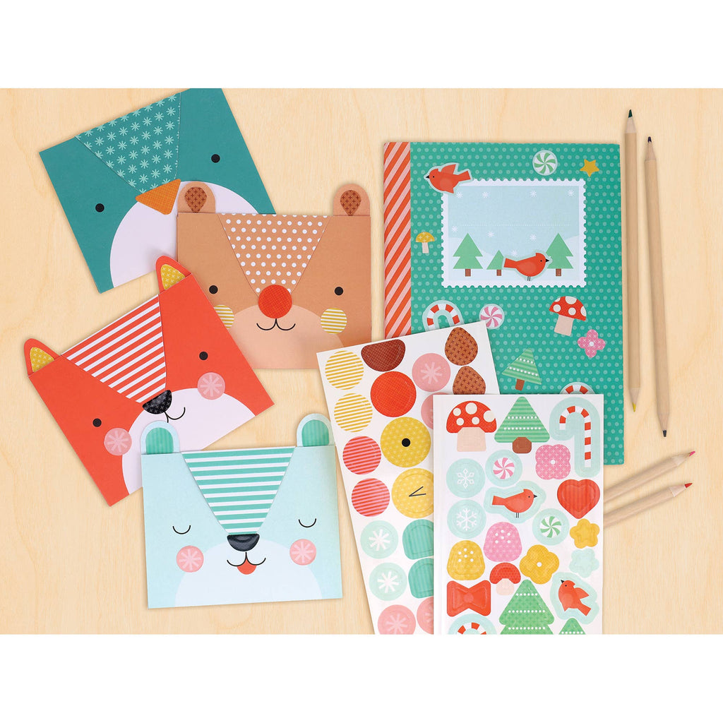 Set of colorful stationery items with animal designs on a wooden surface