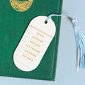 White motivational tag on a green book with a tassel
