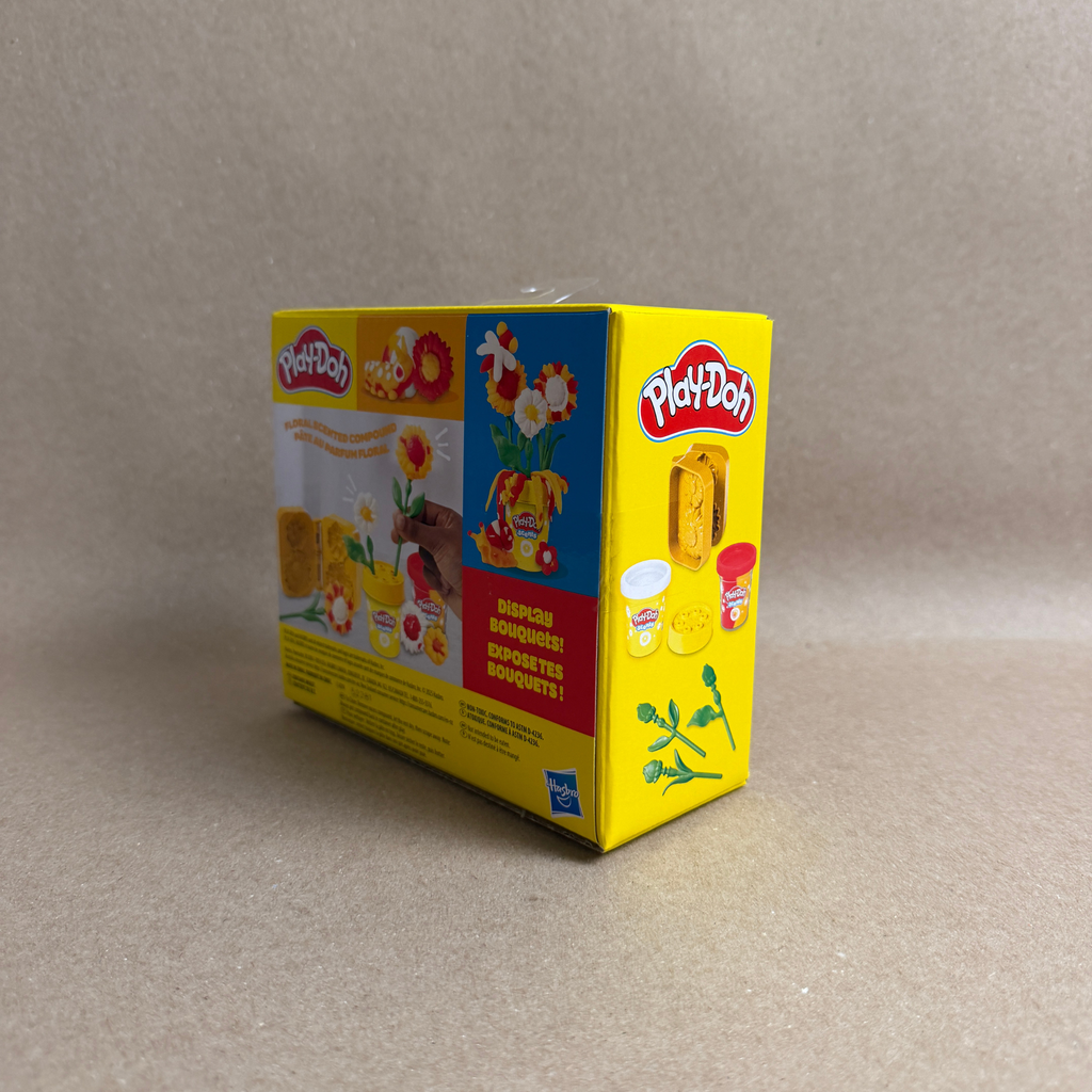 Yellow Play-Doh packaging on a gray background