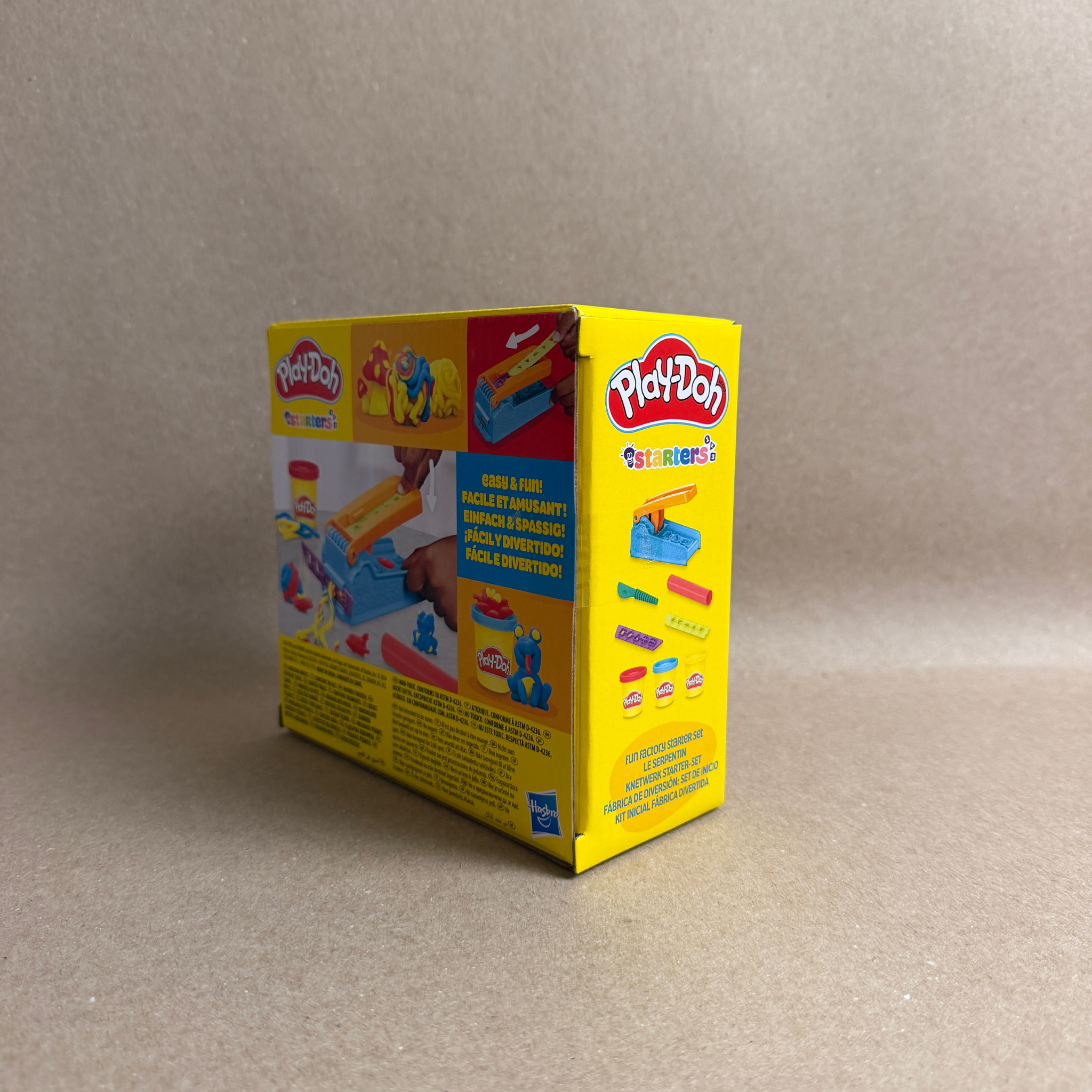 Play-Doh packaging on a beige background