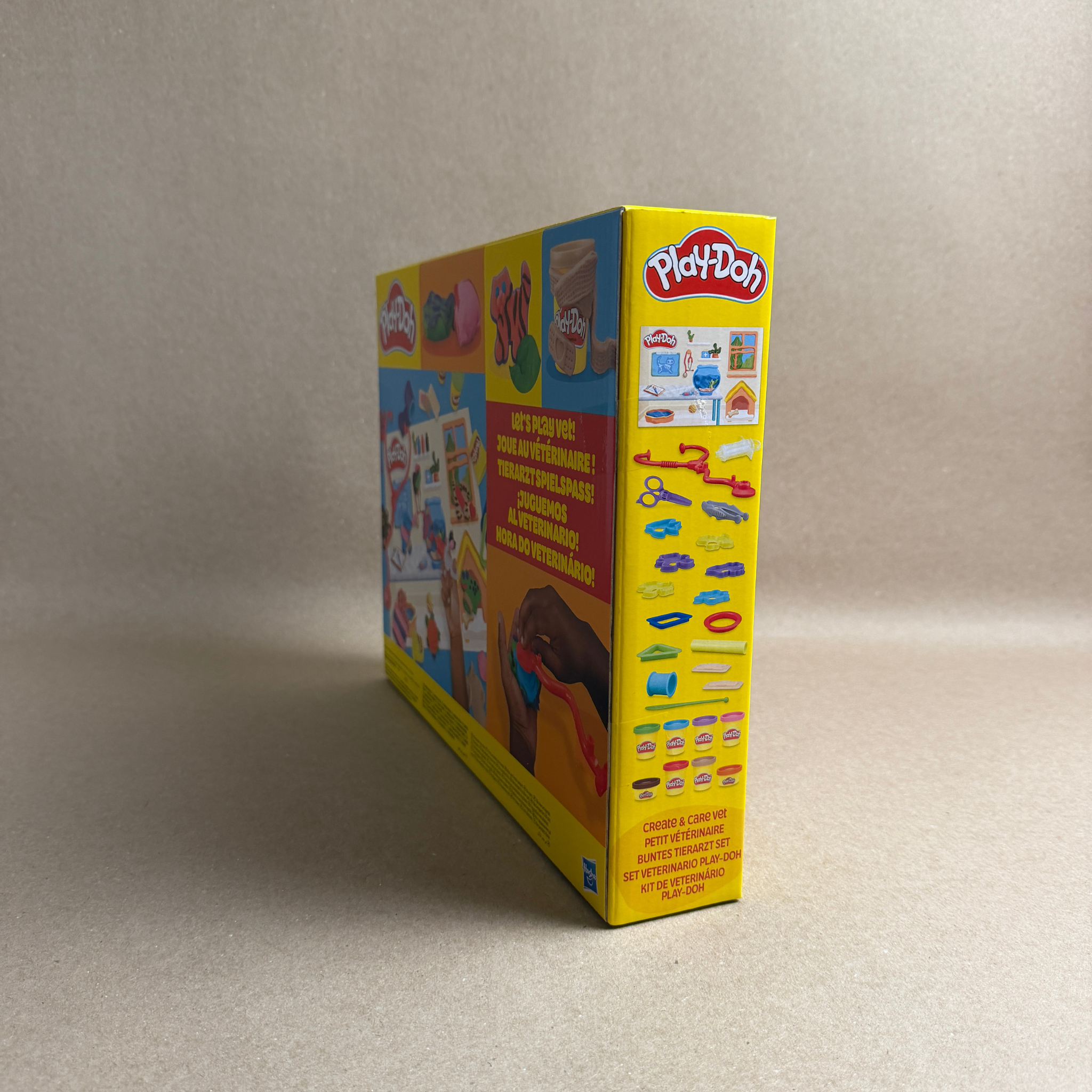 Play-Doh box with colorful design on a beige background