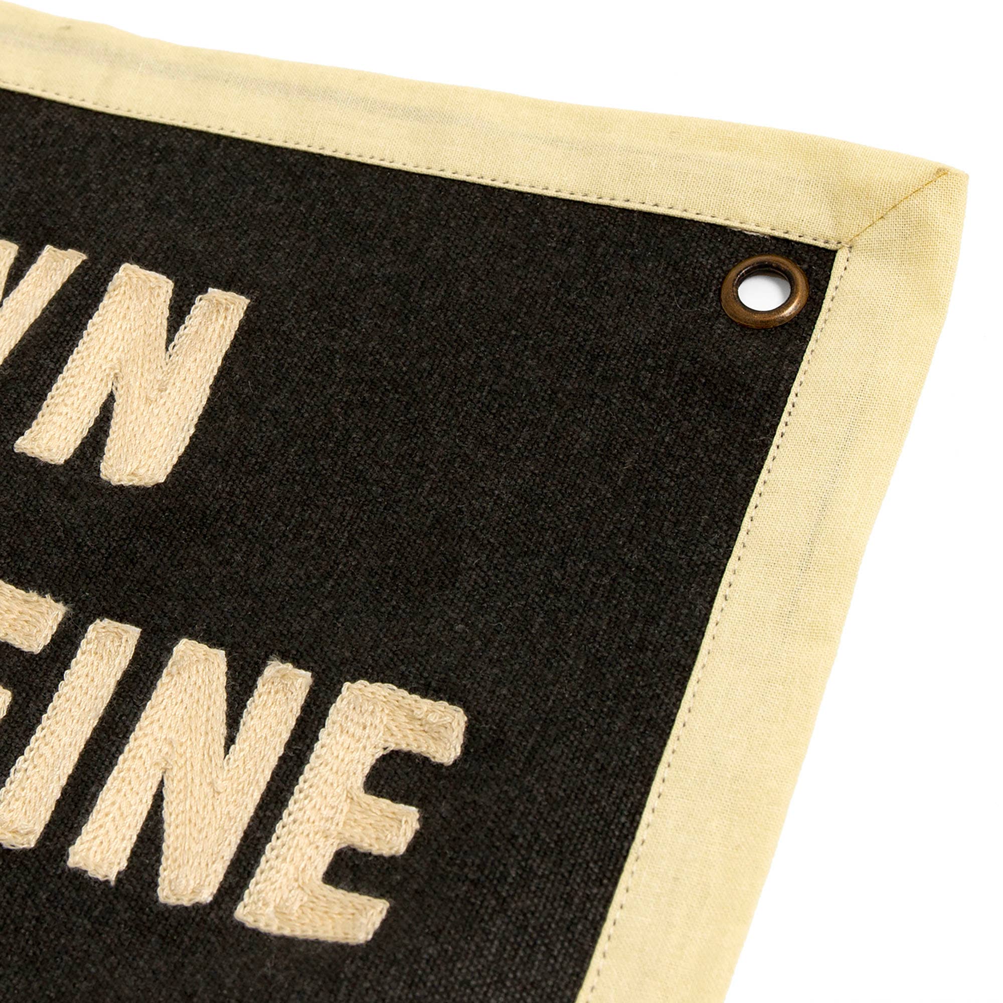 Black canvas banner with cream embroidered text and metal grommet, cozy home decor