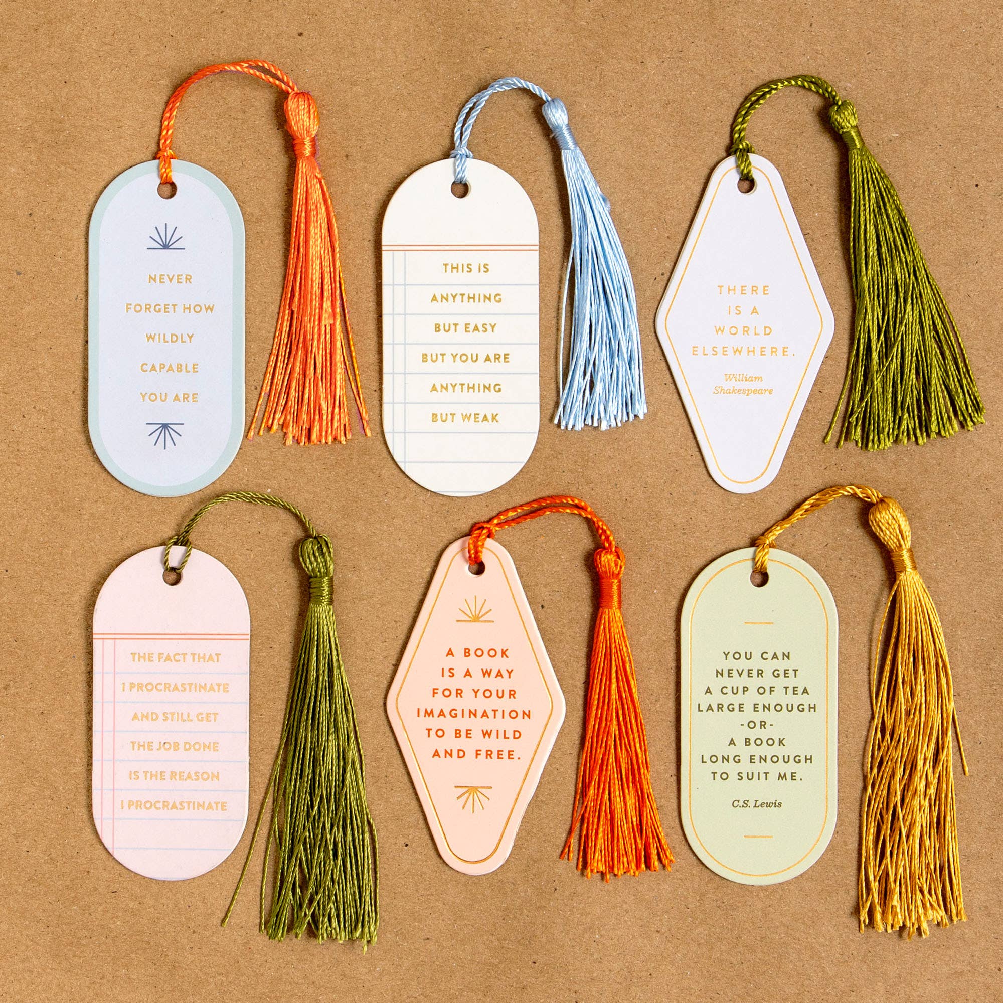 Set of six decorative bookmarks with tassels on a brown background
