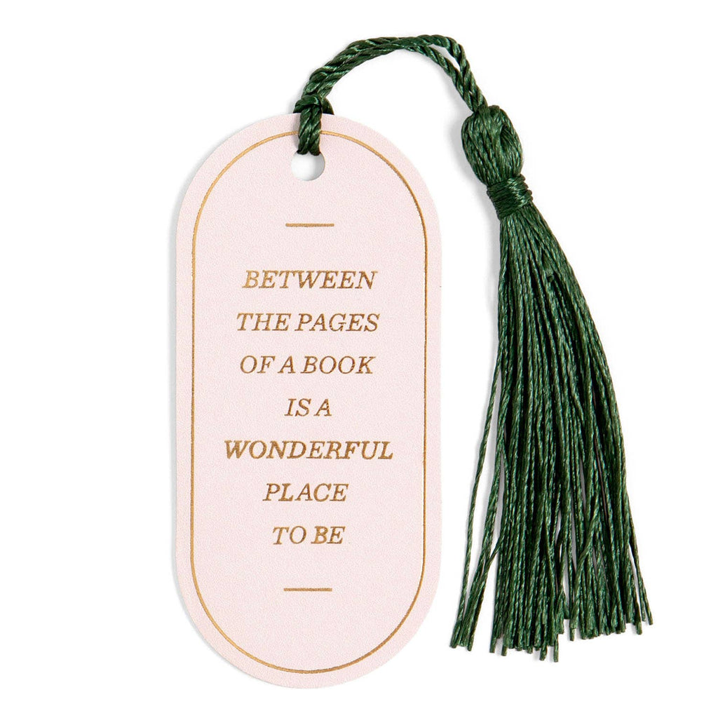 Pink bookmark with green tassel and motivational quote on a white background