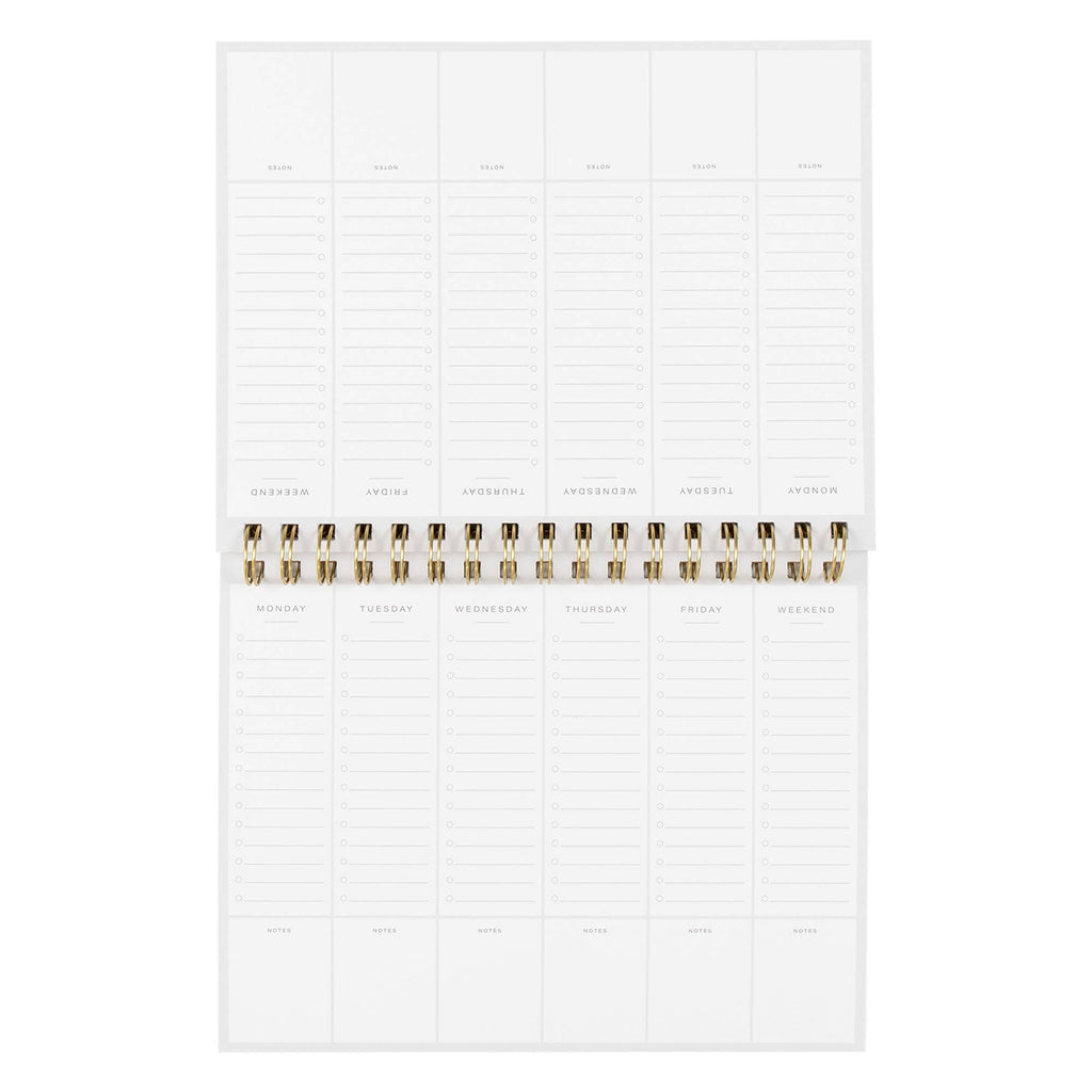White planner with gold binding on a white background