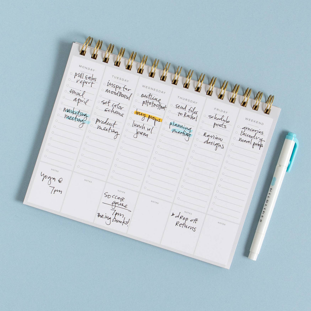 Planner with handwritten tasks on a light blue background