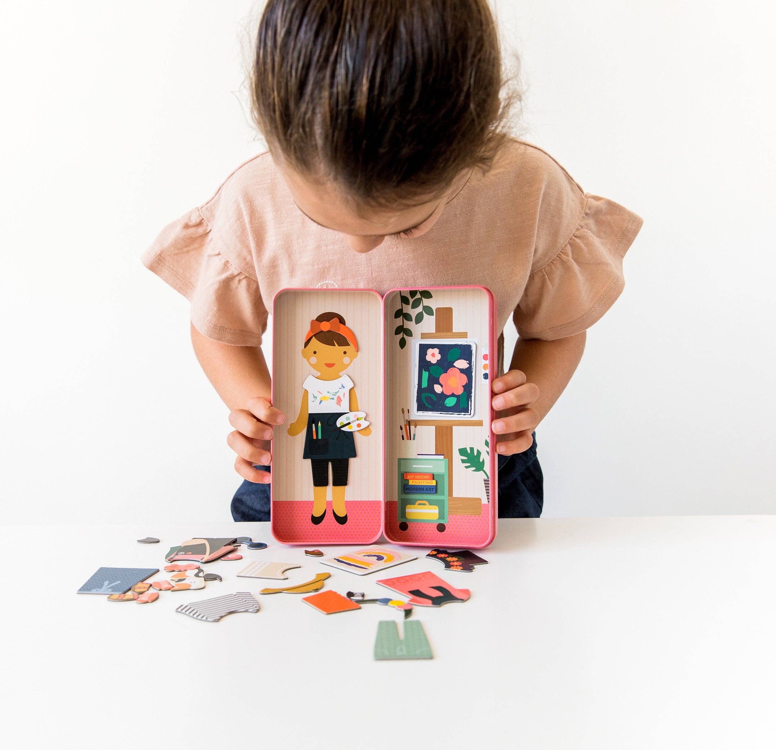 Child playing with magnetic dress-up art studio toy, creative play for kids, colorful magnetic pieces