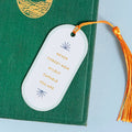 Motivational quote bookmark with tassel on a green book
