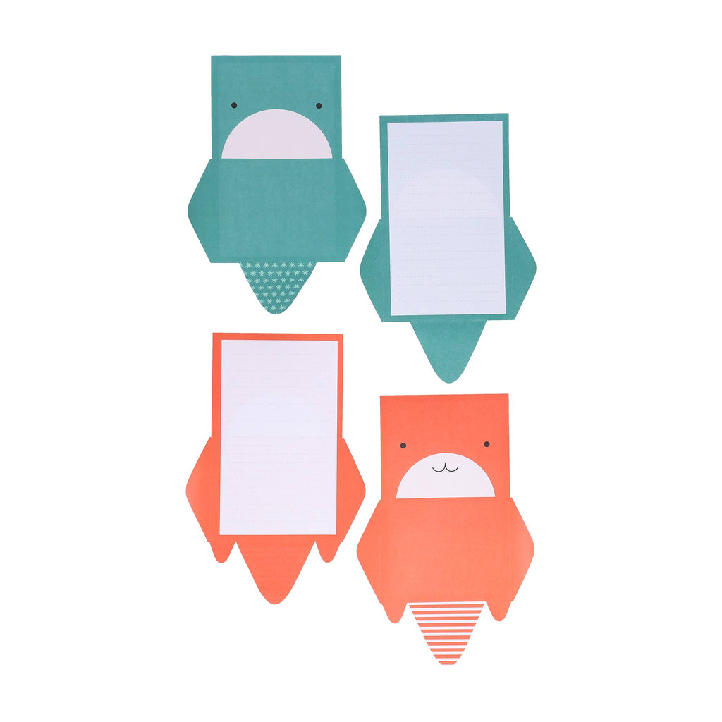Two green and two orange animal-shaped notepads on a white background