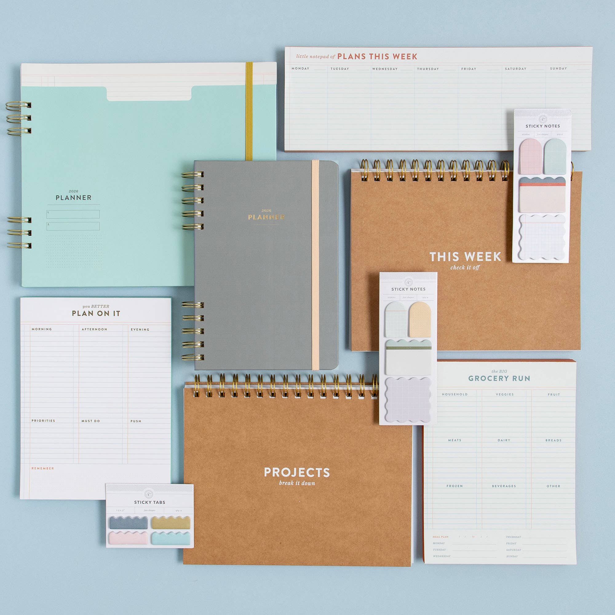 Collection of planners and organizational tools on a light blue background