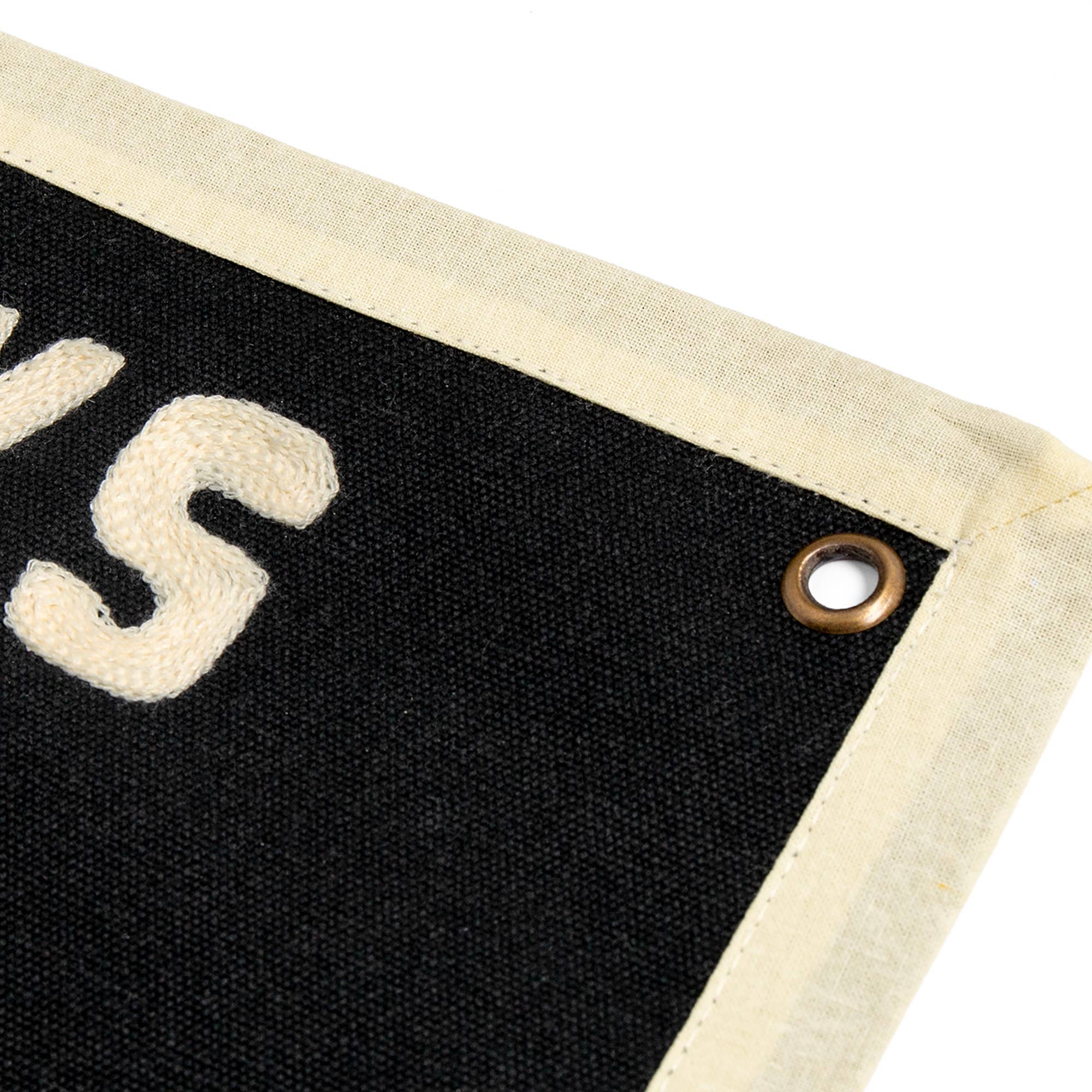 Black canvas banner with cream rope lettering and brass grommet, ideal for cozy home decor or intentional play spaces.
