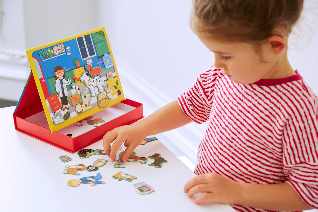 Child playing with magnetic pet vet playset, colorful animal magnets for imaginative play and learning