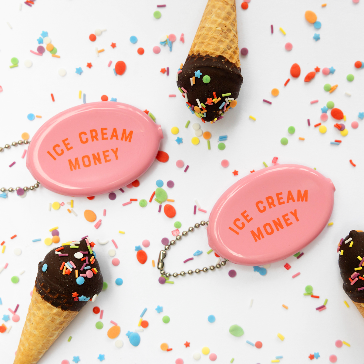 Pink 'Ice Cream Money' pouches with chocolate ice cream cones on a colorful sprinkles background