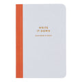 Notebook with orange strap and 'Write it Down (overthink it later)' text on a white background