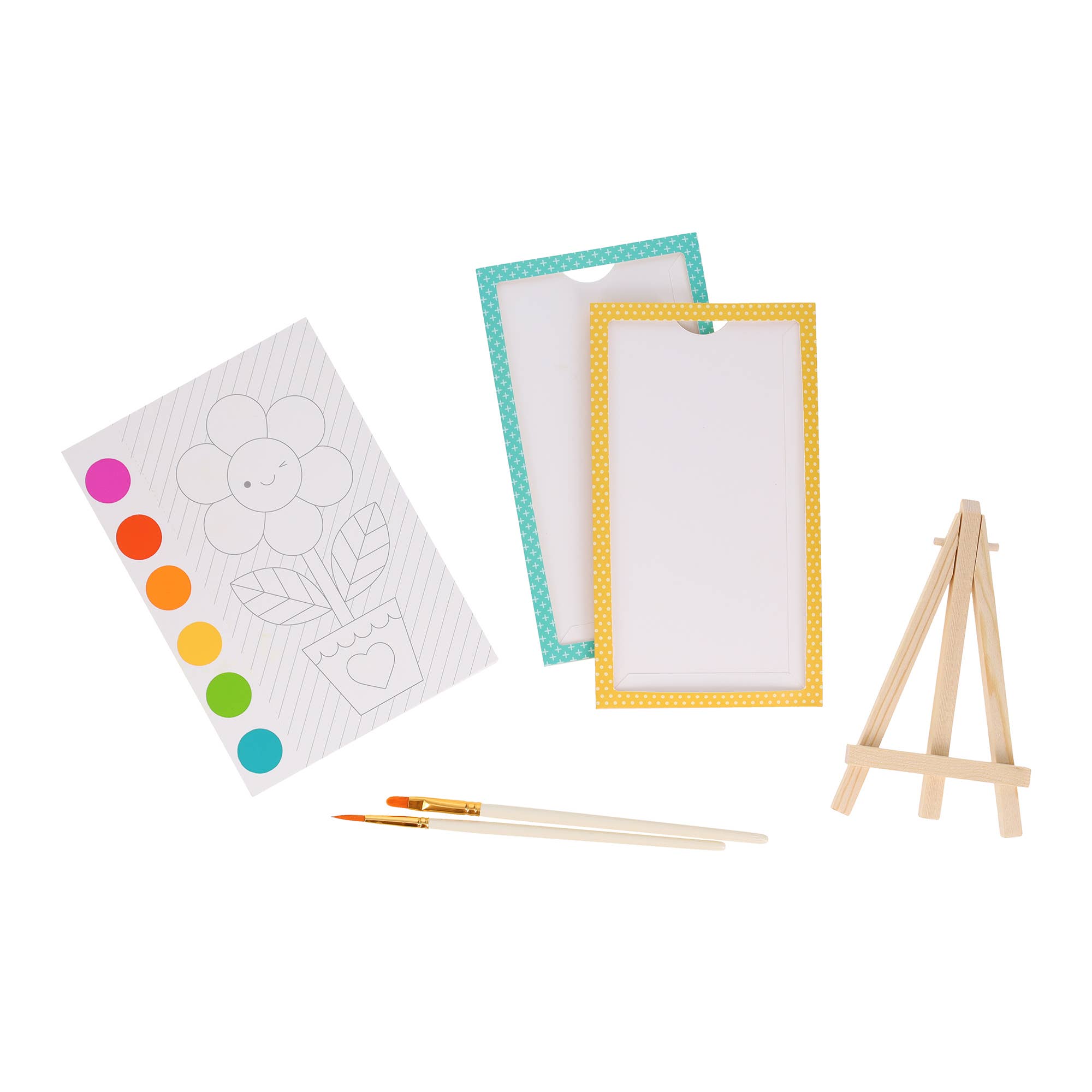 Artistic set with coloring book, paintbrushes, and small easel on a white background