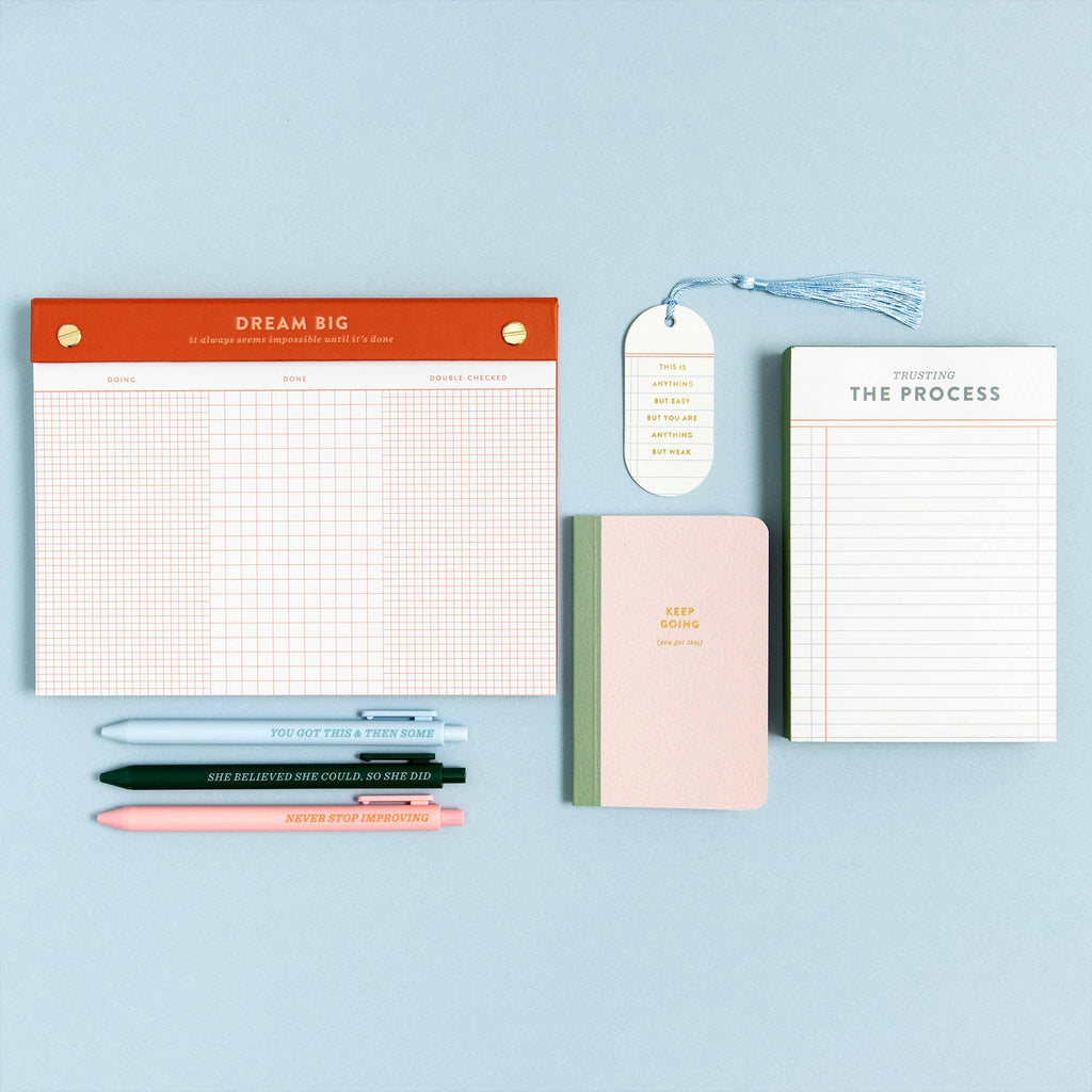 Motivational planners, notebooks, and pens with inspiring quotes for intentional productivity and cozy journaling.