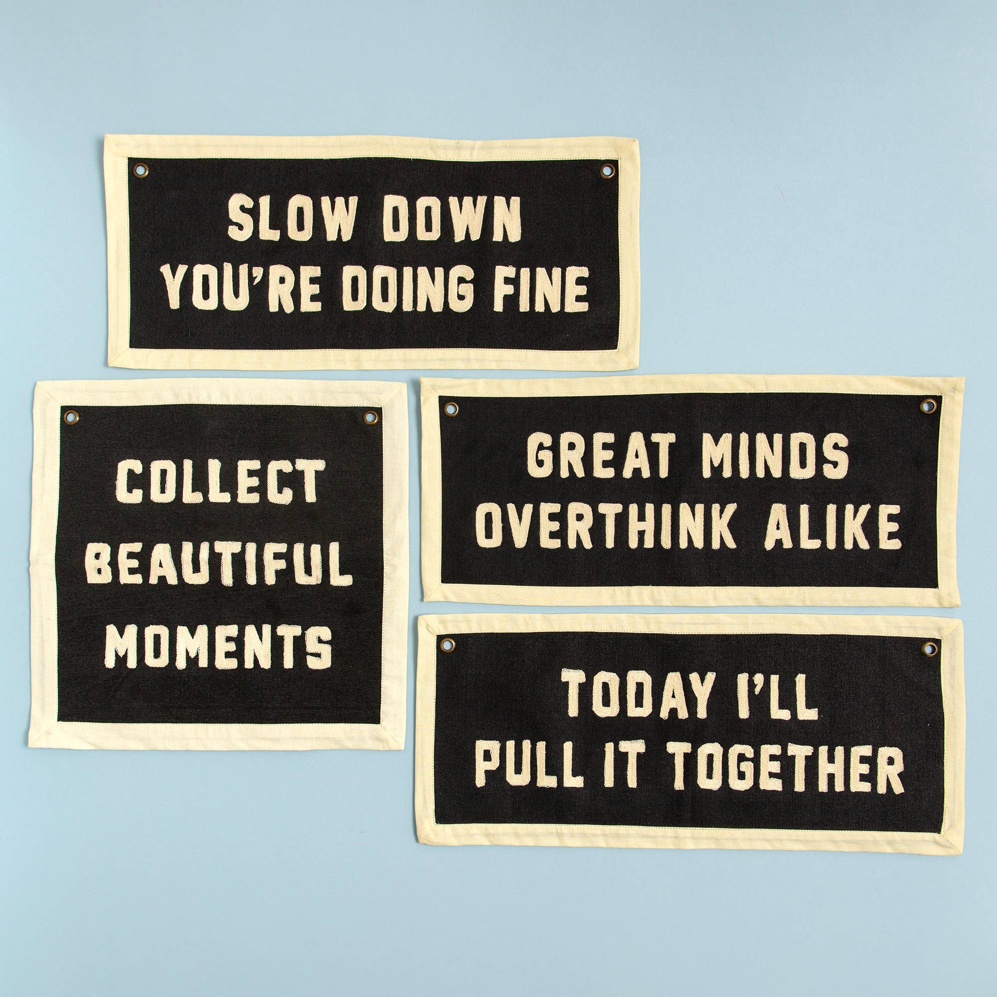 Set of four motivational fabric signs with phrases like 'Slow Down You're Doing Fine' and 'Collect Beautiful Moments' for cozy home decor.