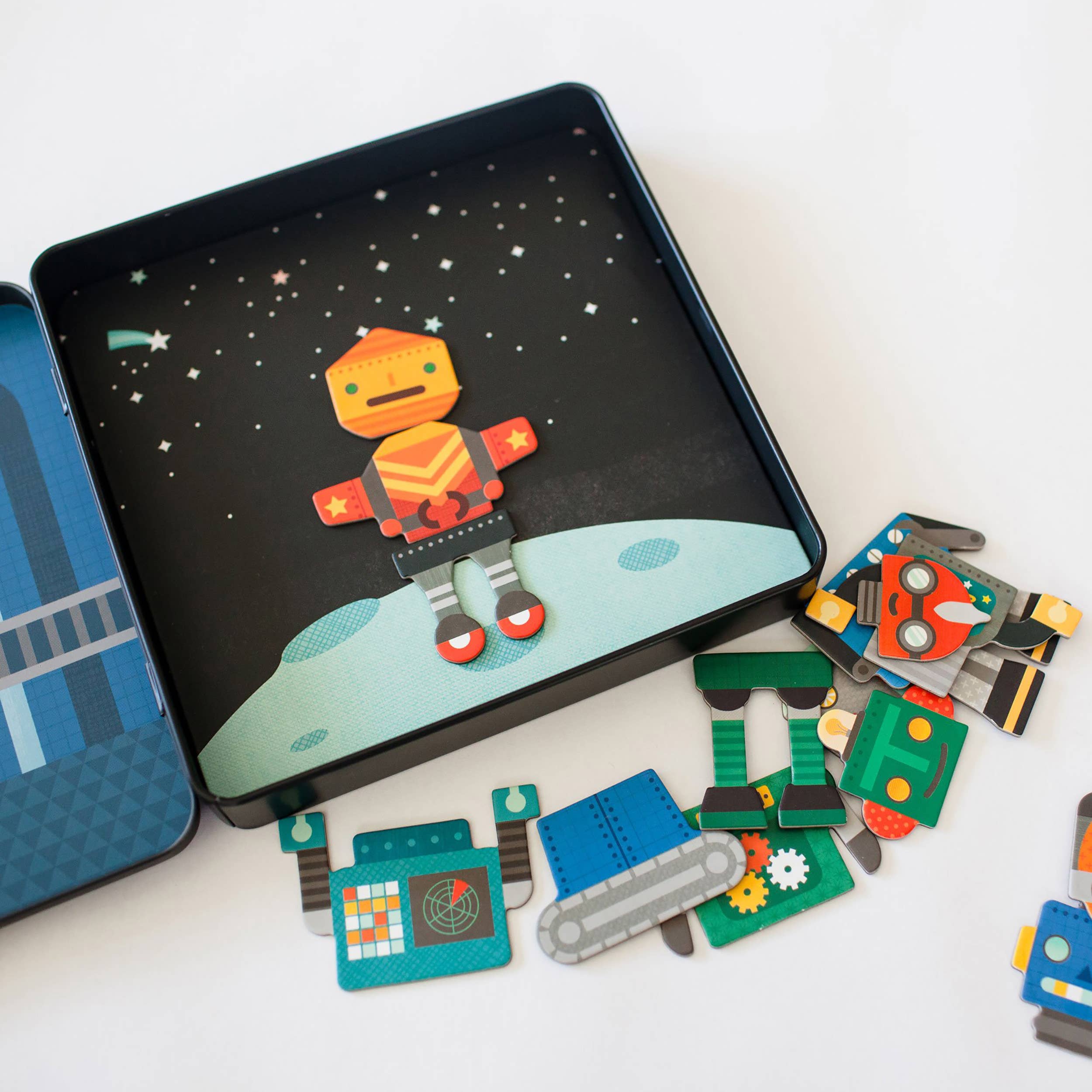 Colorful robot puzzle pieces in space-themed tin, perfect for kids' imaginative play and learning.