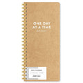Brown planner with 'One Day at a Time' text on a white background